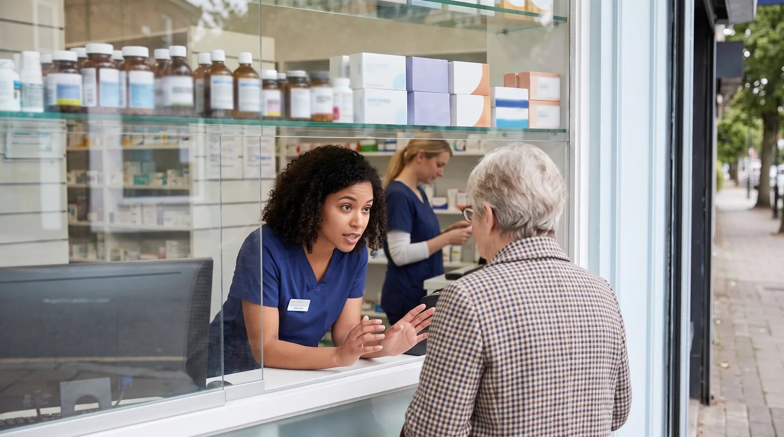 Pharmacy Google Business Profile photos showing storefront, interior, and team images in the local pack
